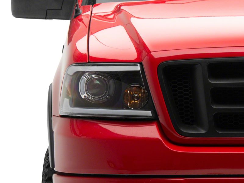 Raxiom 04-08 Ford F-150 Axial Series Projector Headlights w/ SEQL LED Bar- Blk Housing (Clear Lens) Headlights Raxiom
