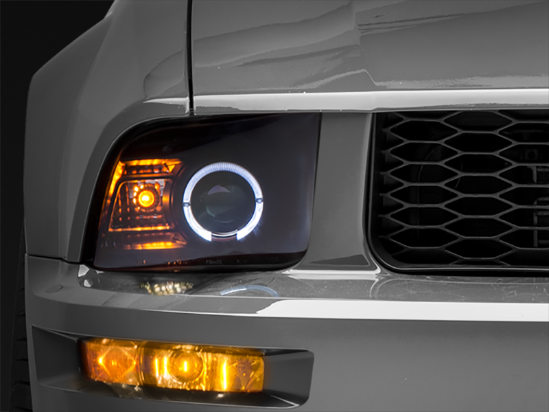 Raxiom 05-09 Ford Mustang Halogen 2010 Style LED Halo Headlights-Blk Hsng(Clear Lens/Excludes GT500) Headlights Raxiom
