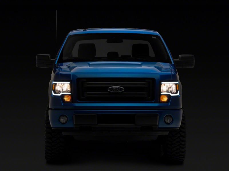 Raxiom 09-14 Ford F-150 Axial Series Headlights w/ LED Bar- Blk Housing (Clear Lens) Headlights Raxiom