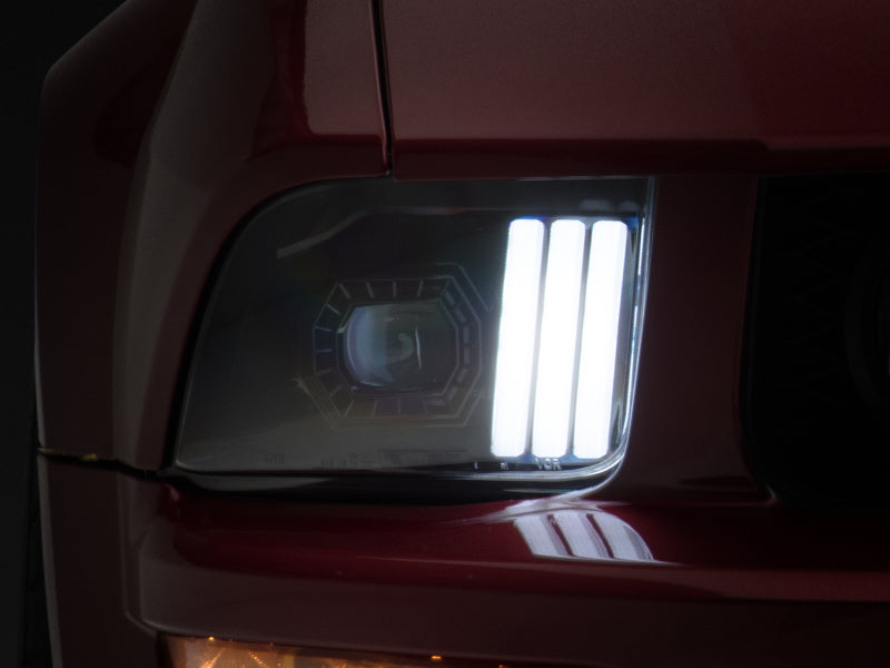 Raxiom 05-09 Ford Mustang w/ Halogen Prjctor Headlights- Black Housing (Clear Lens) (No GT500 ) Headlights Raxiom