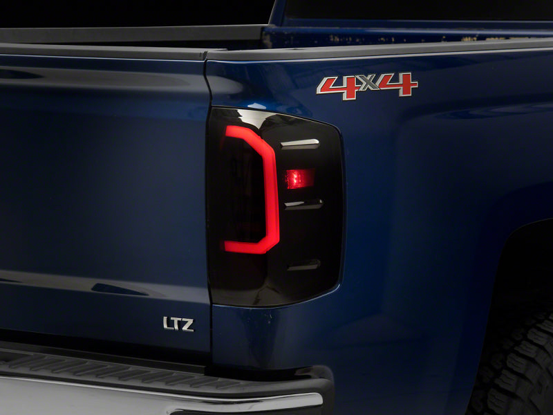 Raxiom 14-18 Chevrolet Silverado 1500 Axial Series LED Tail Lights- Blk Housing (Smoked Lens) Tail Lights Raxiom