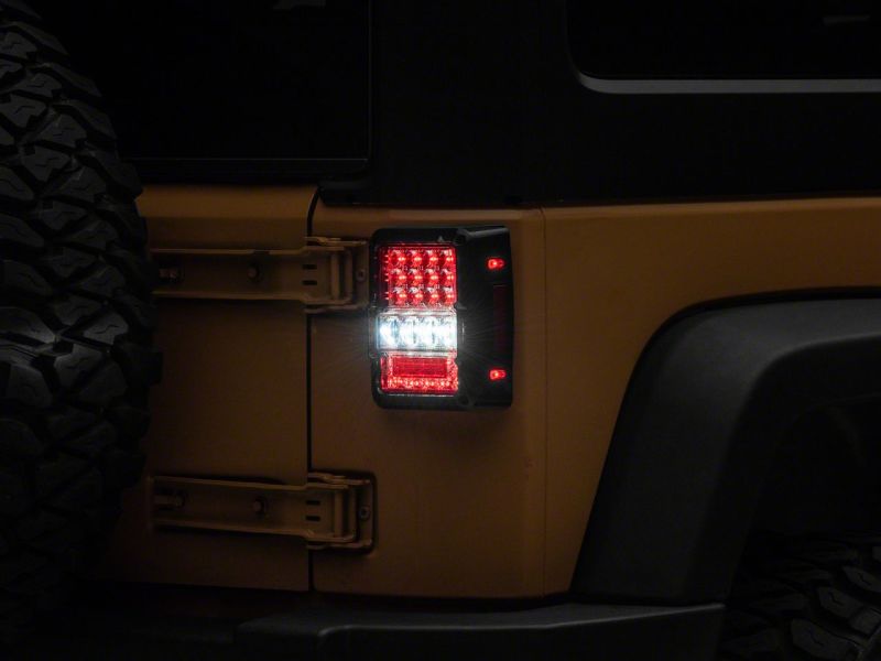 Raxiom 07-18 Jeep Wrangler JK Axial Series Lux LED Tail Lights- Blk Housing (Clear Lens) Tail Lights Raxiom