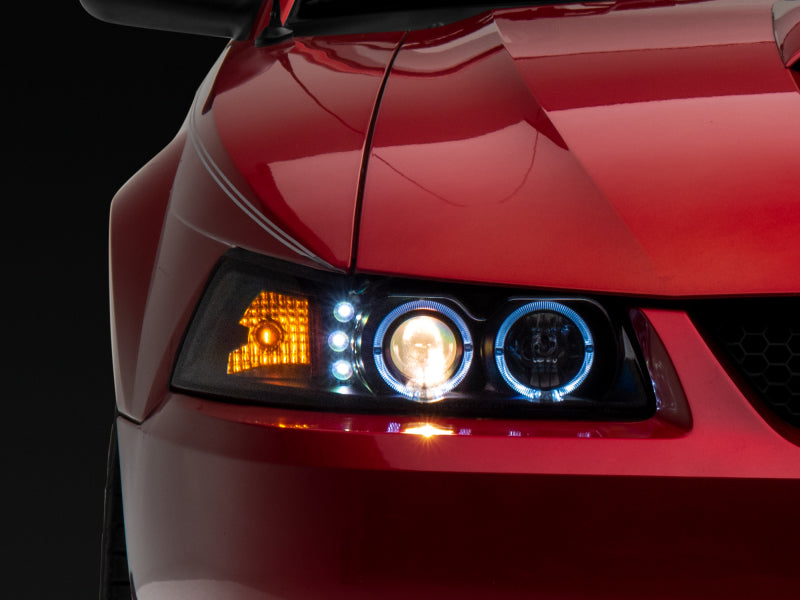 Raxiom 99-04 Ford Mustang Dual LED Halo Projector Headlights- Black Housing (Clear Lens) Headlights Raxiom