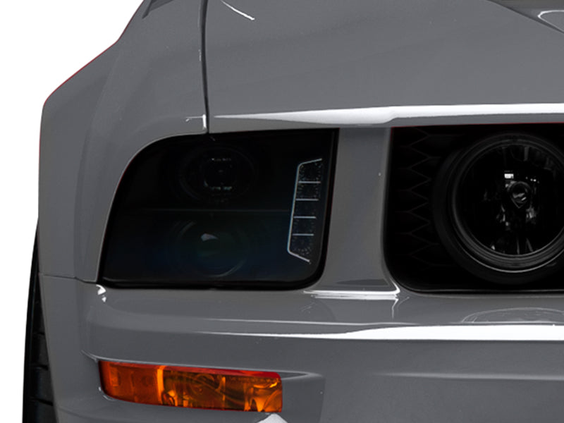 Raxiom 05-09 Ford Mustang w/ Halogen LED Halo Prjctr Headlights-Blk Hsng(Smoked Lens Exclude GT500) Headlights Raxiom