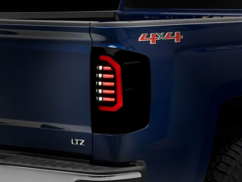 Raxiom 14-18 Chevrolet Silverado 1500 Axial Series LED Tail Lights- Blk Housing (Smoked Lens) Tail Lights Raxiom