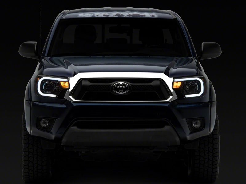Raxiom 12-15 Toyota Tacoma Axial Series Projector Headlights w/ LED Bar- Black Housing (Clear Lens) Headlights Raxiom