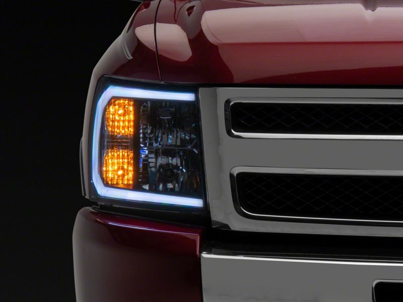 Raxiom 07-13 Chevrolet Silverado 1500 Axial Headlights w/ SEQL LED Bar- Black Housing (Clear Lens) Headlights Raxiom