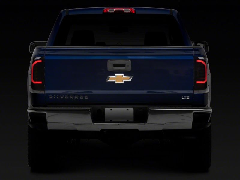 Raxiom 14-18 Chevrolet Silverado 1500 Axial Series LED Tail Lights- Blk Housing (Smoked Lens) Tail Lights Raxiom