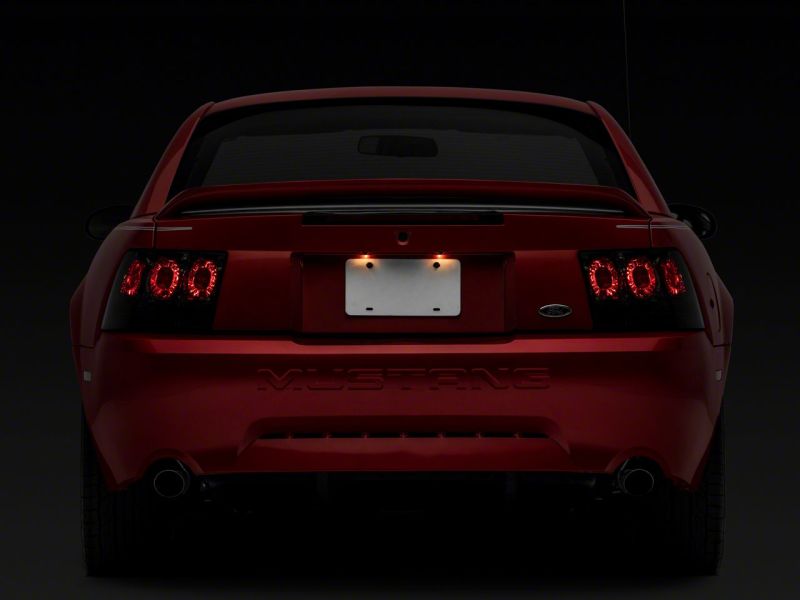 Raxiom 99-04 Ford Mustang Axial Series Altezza Style Tail Lights- Blk Housing (Smoked Lens) Tail Lights Raxiom