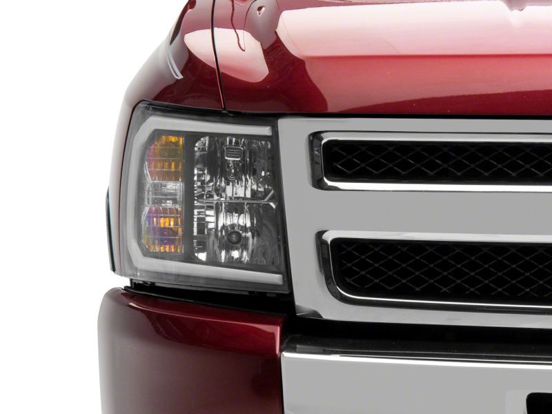 Raxiom 07-13 Chevrolet Silverado 1500 Axial Series Headlights w/ LED Bar- Black Housing (Clear Lens) Headlights Raxiom