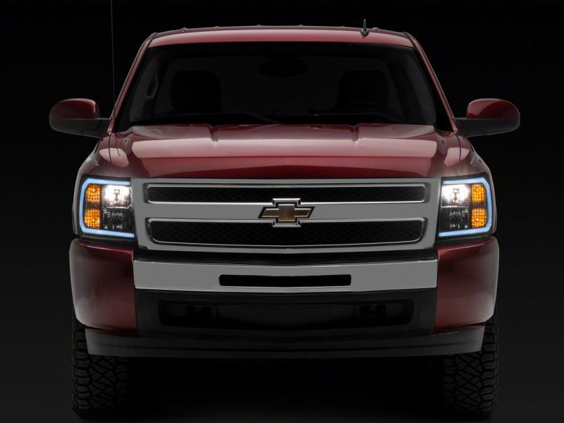 Raxiom 07-13 Chevrolet Silverado 1500 Axial Series Headlights w/ LED Bar- Black Housing (Clear Lens) Headlights Raxiom