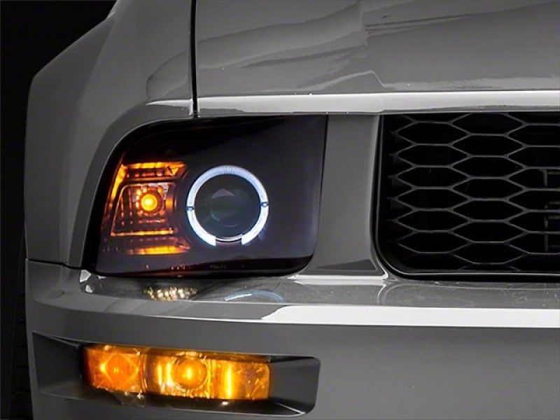 Raxiom 05-09 Ford Mustang Halogen 2010 Style LED Halo Headlights-Blk Hsng(Clear Lens/Excludes GT500) Headlights Raxiom