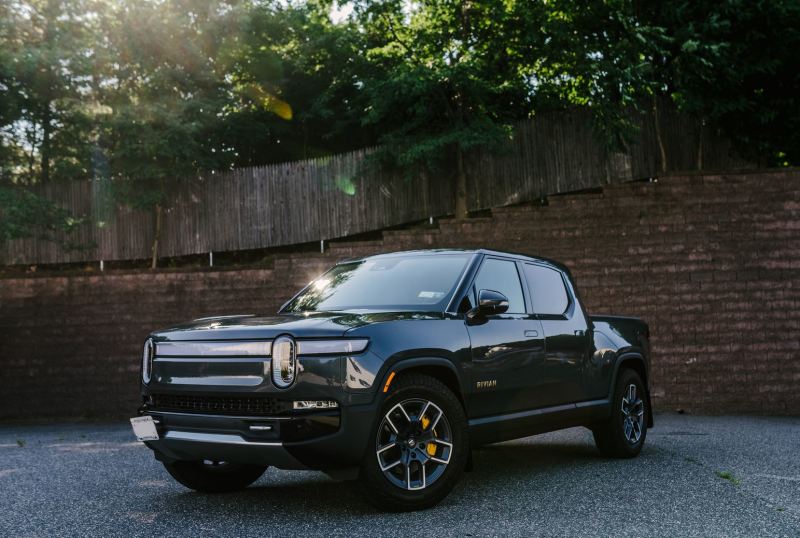 Rally Armor 22-25 Rivian R1T Black UR Mud Flap w/Tangerine Scream Logo Mud Flaps Rally Armor