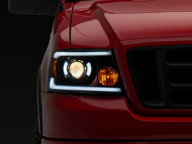 Raxiom 04-08 Ford F-150 Axial Series Projector Headlights w/ SEQL LED Bar- Blk Housing (Clear Lens) Headlights Raxiom