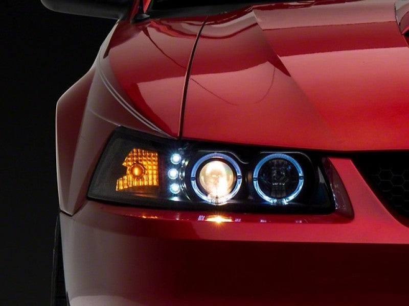 Raxiom 99-04 Ford Mustang Dual LED Halo Projector Headlights- Black Housing (Clear Lens) Headlights Raxiom