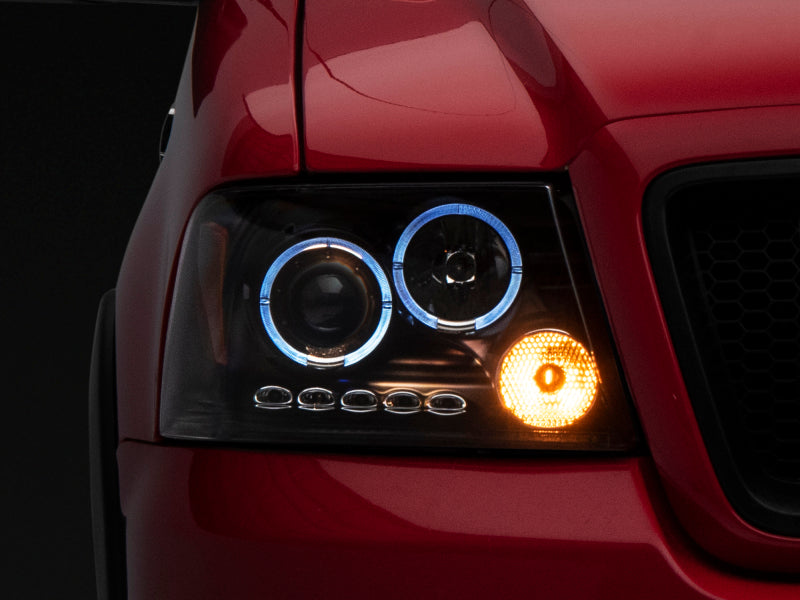 Raxiom 04-08 Ford F-150 Dual LED Halo Projector Headlights- Black Housing (Clear Lens) Headlights Raxiom