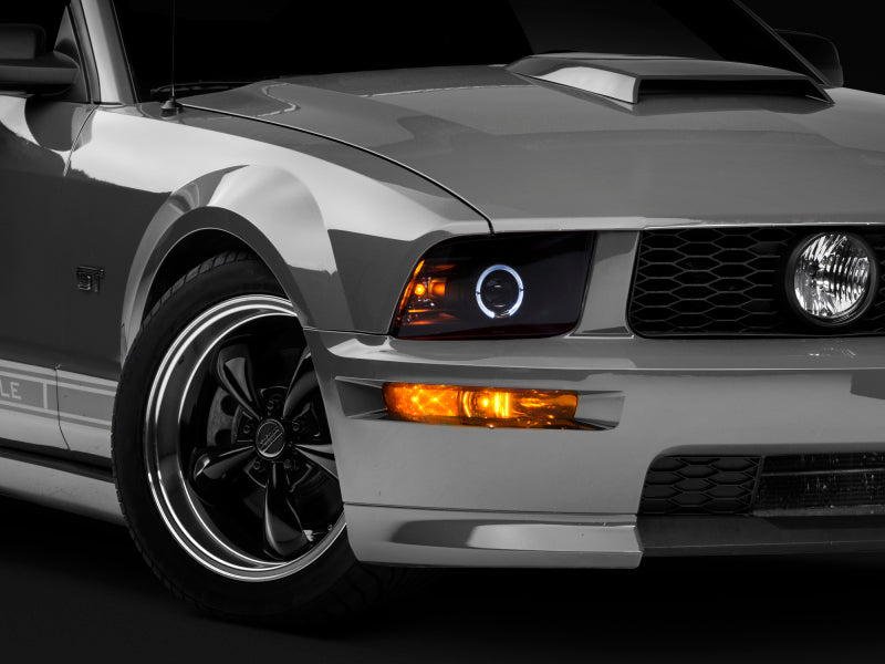 Raxiom 05-09 Ford Mustang Halogen 2010 Style LED Halo Headlights-Blk Hsng(Clear Lens/Excludes GT500) Headlights Raxiom