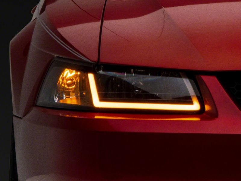 Raxiom 99-04 Ford Mustang Axial Series Headlights w/ Sequential LED Bar- Blk Housing (Clear Lens) Headlights Raxiom