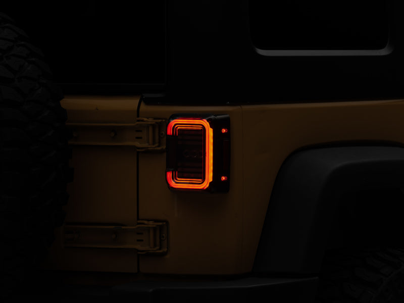 Raxiom 07-18 Jeep Wrangler JK Axial Series LED Halo Tail Lights- Black Housing (Dark Smoked Lens) Tail Lights Raxiom