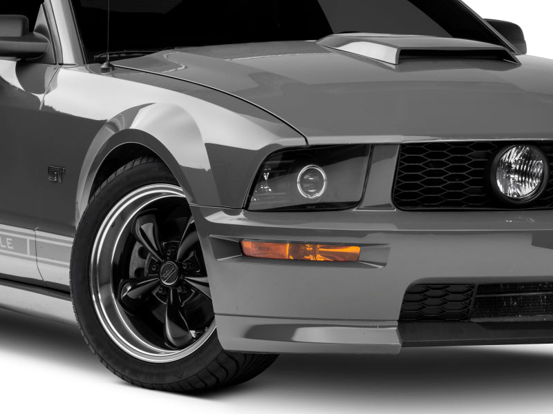 Raxiom 05-09 Ford Mustang Halogen 2010 Style LED Halo Headlights-Blk Hsng(Clear Lens/Excludes GT500) Headlights Raxiom