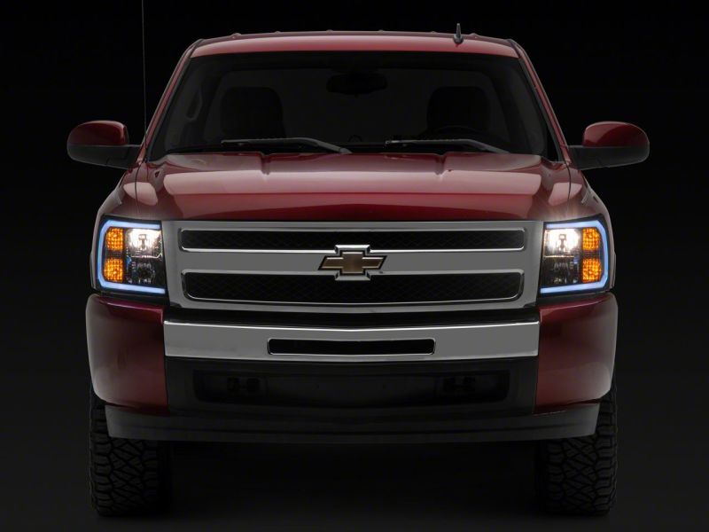 Raxiom 07-13 Chevrolet Silverado 1500 Axial Headlights w/ SEQL LED Bar- Black Housing (Clear Lens) Headlights Raxiom