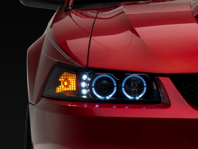 Raxiom 99-04 Ford Mustang Dual LED Halo Projector Headlights- Black Housing (Clear Lens) Headlights Raxiom