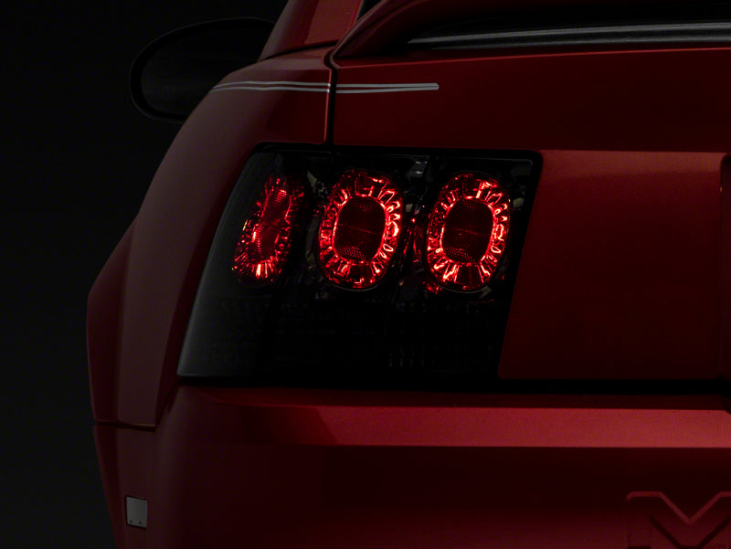 Raxiom 99-04 Ford Mustang Axial Series Altezza Style Tail Lights- Blk Housing (Smoked Lens) Tail Lights Raxiom