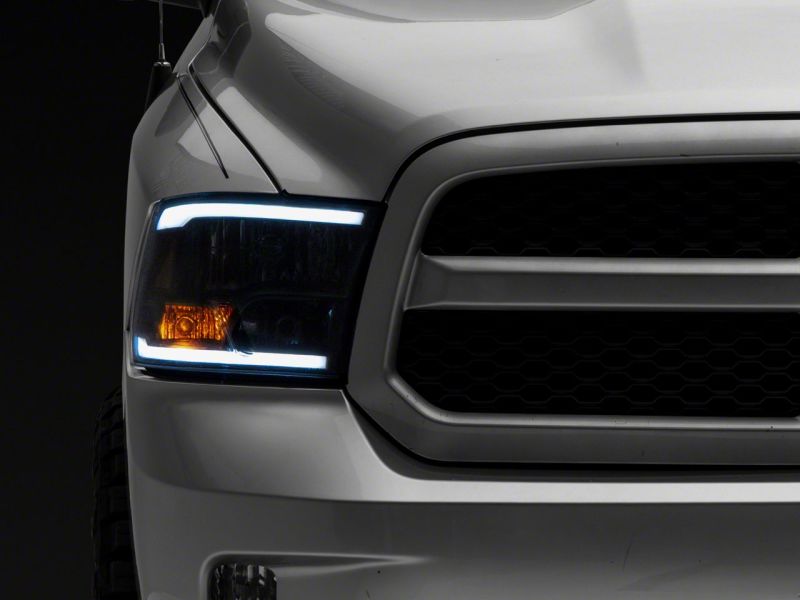 Raxiom 09-18 Dodge RAM 1500/2500/3500 Axial Series Headlights w/ LED Bar- Black Housing (Clear Lens) Headlights Raxiom