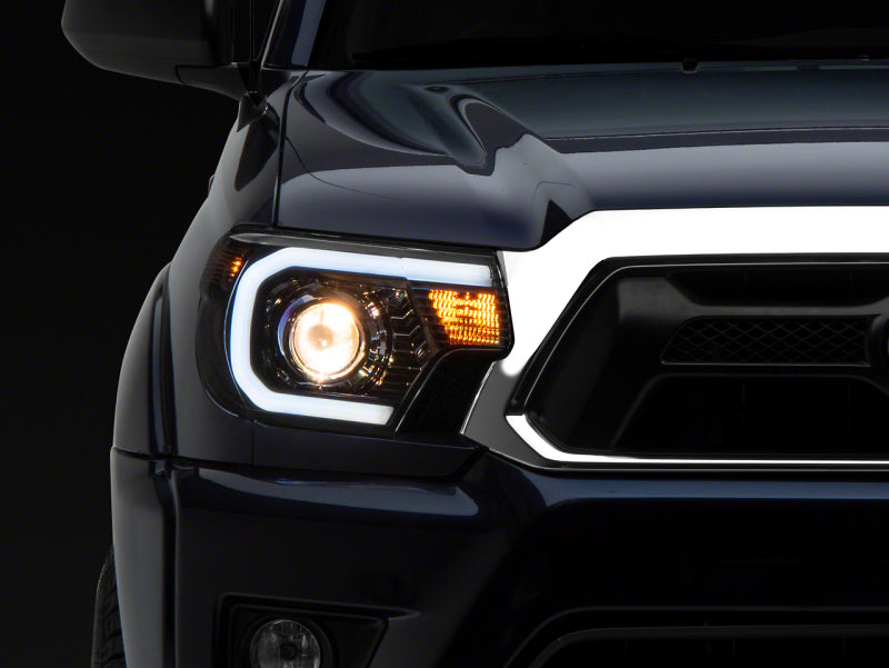 Raxiom 12-15 Toyota Tacoma Axial Series Projector Headlights w/ LED Bar- Black Housing (Clear Lens) Headlights Raxiom