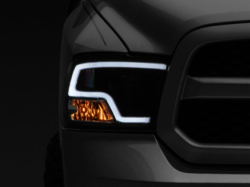 Raxiom 09-18 RAM 1500 LED Halo Projector Headlights- Black Housing (Clear Lens) Headlights Raxiom
