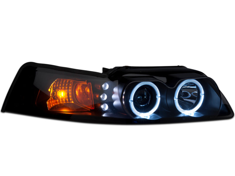 Raxiom 99-04 Ford Mustang Dual LED Halo Projector Headlights- Black Housing (Smoked Lens) Headlights Raxiom