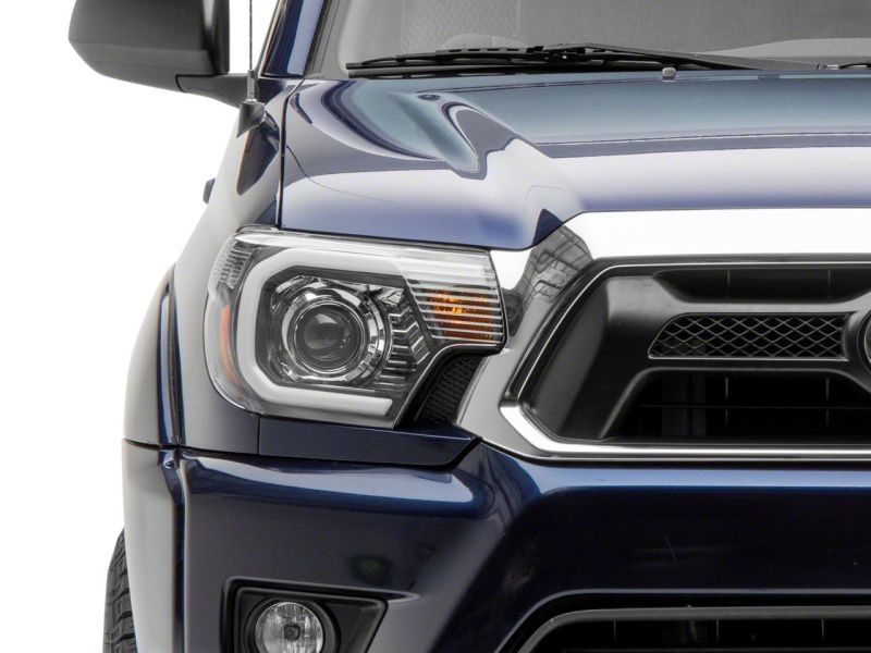 Raxiom 12-15 Toyota Tacoma Axial Projector Headlights w/ SEQL LED Bar- Black Housing (Clear Lens) Headlights Raxiom