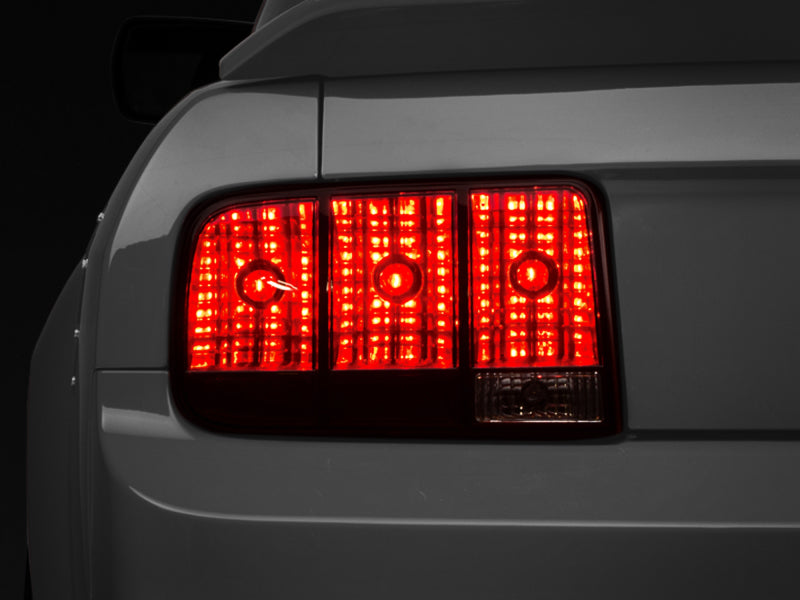 Raxiom 05-09 Ford Mustang Tail Lights- Black Housing (Smoked Lens) Tail Lights Raxiom